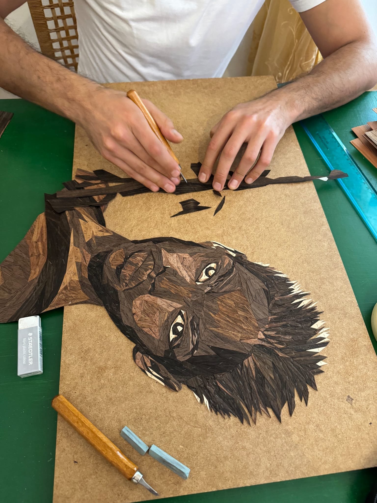 Assembling hundreds of hand-cut veneer pieces