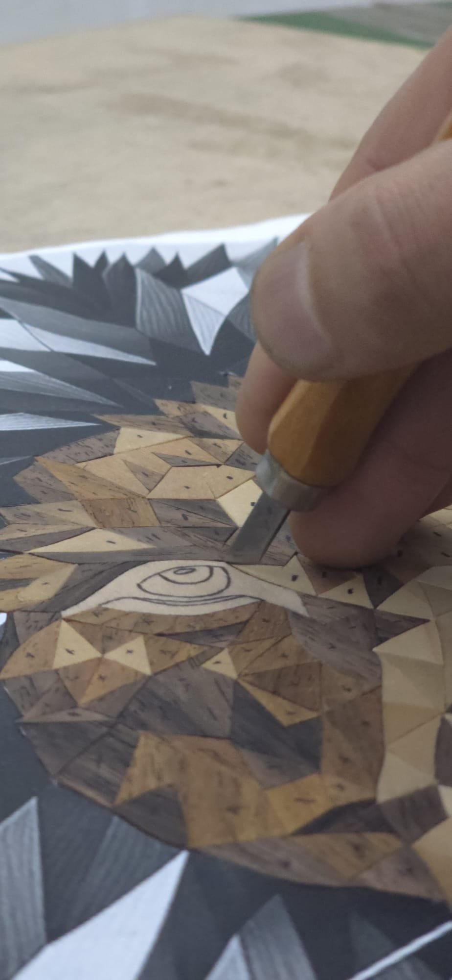 Detail work on a marquetry portrait in progress